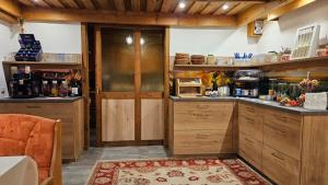 a large kitchen with wooden cabinets and a rug at Haus am Schönberg in Sooss