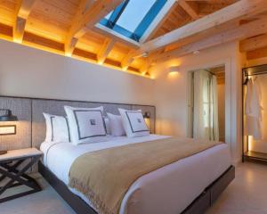 a bedroom with a large white bed with a skylight at La Fonda Heritage Hotel Luxury, Relais & Châteaux in Marbella +97 photos