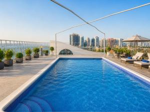 a swimming pool on the roof of a building at Mirador Hotel in Manama