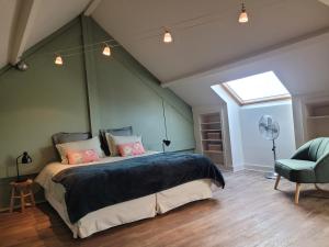 a bedroom with a large bed and a window at L'Annexe de Steph in Loulans-Verchamp