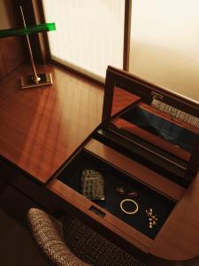 a table with a drawer with a watch and a lamp at The Shepherd Mayfair in London