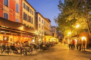 a group of people walking down a street at night at Côté Calade Arles Centre in Arles