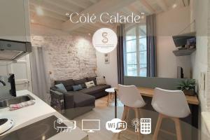 a kitchen and a living room with a couch at Côté Calade Arles Centre in Arles +3 photos