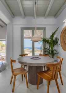 a dining room with a table and chairs at Villa Yasemin - Mykonos Paradise - Views - Pool - Large Garden in Kalafatis
