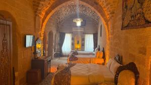 a bedroom with two beds in a large room at Alies Konağı in Mardin