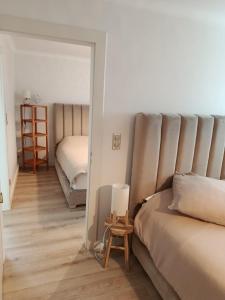 a living room with a bed and a mirror at Très belle chambre à Metz in Metz
