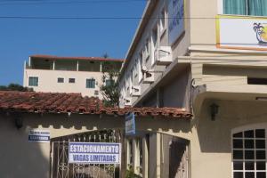 a building with a sign on the side of it at Hotel Nanuque in Cabo Frio +7 photos