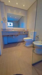 a bathroom with a sink and a toilet and a mirror at Mirador Hotel in Manama +12 photos