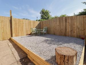 a backyard with a table and chairs and a fence at 41 St James Street in Narberth