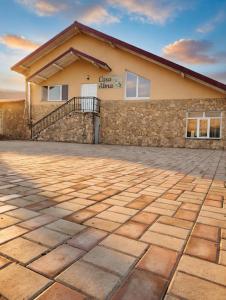 a stone driveway in front of a building at Casa Alma in Paşcani