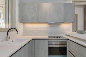a kitchen with stainless steel cabinets and a sink at Villa Yasemin - Mykonos Paradise - Views - Pool - Large Garden in Kalafatis