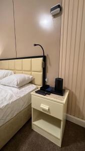 a bedroom with a bed and a desk with a lamp at Rosaio in El Alamein