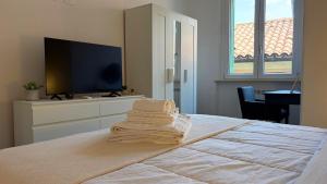 a bedroom with a bed with a flat screen tv at Vista Duomo Foligno in Foligno