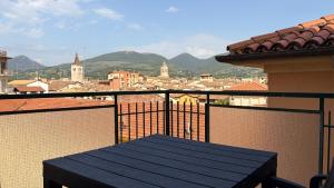 a table on a balcony with a view of a city at Vista Duomo Foligno in Foligno