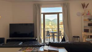 a living room with a couch and a large window at Vista Duomo Foligno in Foligno