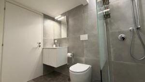 a small bathroom with a toilet and a shower at Vista Duomo Foligno in Foligno +35 photos
