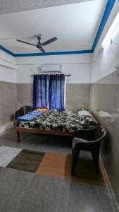 a bedroom with a bed and a ceiling at HOLIDAY HOMEs MALPE in Udupi