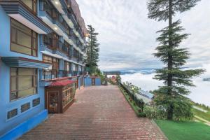 a brick walkway next to a building at The Prakriti Retreat l Pure Veg l Lift l Indoor Multi Cuisine Restaurant l Power Backup Available l Managed By ExoticStays Group in Kūfrī