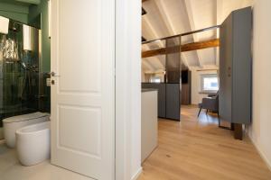 an open door to a bathroom with a toilet at Ca Moroni Collection in Bergamo +60 photos