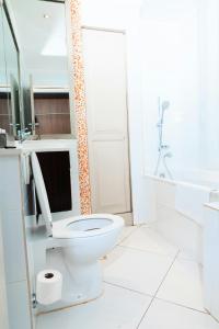 a white bathroom with a toilet and a sink at ONOMO Hotel Cape Town – Inn On The Square in Cape Town