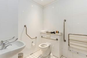 a white bathroom with a toilet and a sink at ONOMO Hotel Cape Town – Inn On The Square in Cape Town