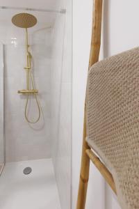 a wooden chair in a bathroom with a shower at Le Cocon Perché - Centre Ville - Parking - Clim in Valence