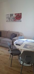 a living room with a couch and a table and chairs at Civico 8 Apartment in Sassari +14 photos