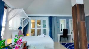 a bedroom with a white bed with a pink duck on it at Bann Sunset Cove Krabi I A Hidden Luxury Escape on Had Yao Beach in Krabi +51 photos