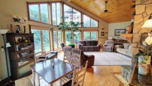 a large living room with a table and chairs at North River Inn in Bridgewater