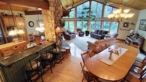 a kitchen and living room with a large wooden table at North River Inn in Bridgewater