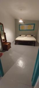 an empty room with a bed and a mirror at Sun Rock Villa Arugambay in Arugam Bay +15 photos