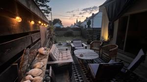 an outdoor patio with a table and chairs and a table at Chambre d'hôtes Ouest Laurent Vidal in Plouharnel