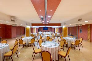 a banquet hall with white tables and chairs at Grand Hotel del Parco in Stezzano