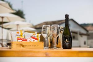 a bottle of wine and glasses on a table at Masseria Marotta in Santa Paolina +13 photos
