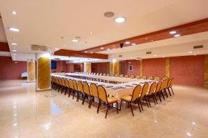 a large banquet hall with a long table and chairs at Grand Hotel del Parco in Stezzano
