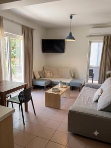 a living room with a couch and a table at Kleanthi Studios in Chania
