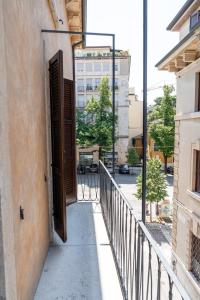 an open door on a balcony with a building at Montenero City Rooms in Verona