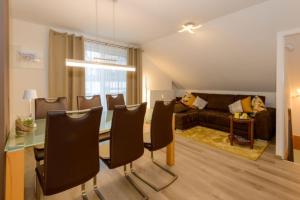a living room with a table and a couch at Feriendorf Schwarzholz in Viechtach