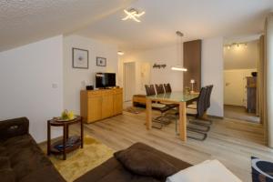 a living room and dining room with a table and chairs at Feriendorf Schwarzholz in Viechtach
