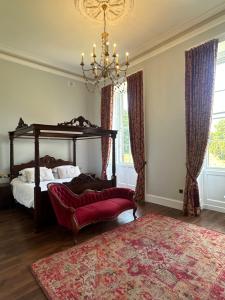 a bedroom with a canopy bed and a red rug at Uppercourt Manor in Freshford