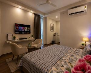 a hotel room with a bed and a table and chairs at stay elan in Greater Noida