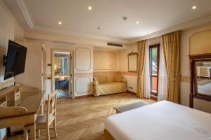 a hotel room with a bed and a couch at Hotel Villa San Pio in Rome