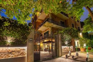 an apartment building with a gate in front of it at Hotel Villa San Pio in Rome