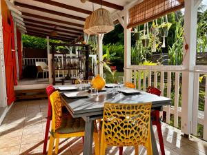 a dining table and chairs on a patio at Kaz'Arawak in Sainte-Rose