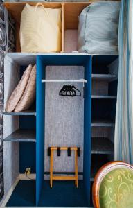 a bedroom with a bunk bed with a blue shelf at Chambre d'hôtes Bounty - terrasse, cuisine privée, garage in Olliergues