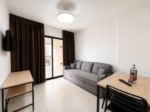 a living room with a couch and a table at Luxmar Apartaments By MC in Benidorm