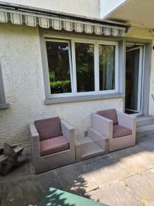 two chairs sitting outside of a house at YveSkinYoga in Zurich