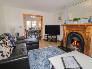 a living room with a couch and a fireplace at The Sperrin Getaway in Omagh