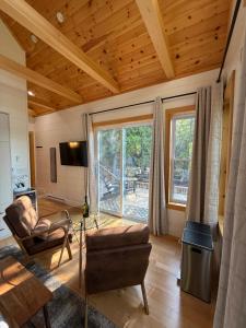 a living room with a couch and a chair at Dock 124 - Adults Only, Waterfront B&B in Tobermory +24 photos