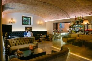 a room with couches and a bar with two people at Hotel Villa San Pio in Rome +23 photos